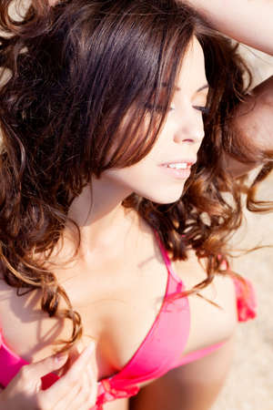 Beautiful brunette in bikini on the beachの写真素材
