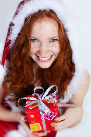 Beautiful redhead girl in christmas dressの写真素材