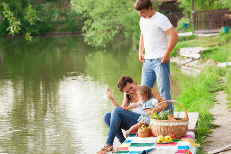 Family on picnic near the lakeの写真素材