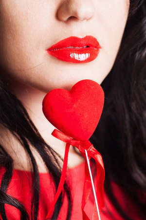 Girl with red heart in hand