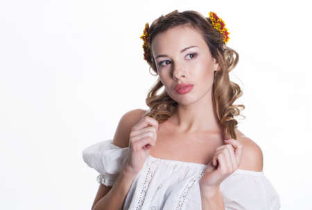 Beautiful girl with chrysanthemum wreathの写真素材