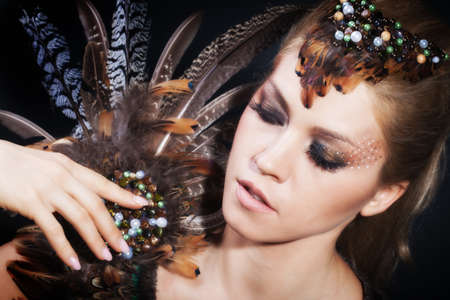 Woman portrait with featherの写真素材