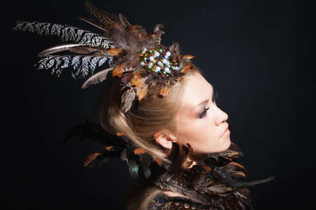 Woman portrait with featherの写真素材