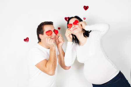 Pregnancy young woman with man in studio 