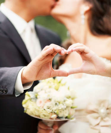 Bride and groom make heart symbolの写真素材
