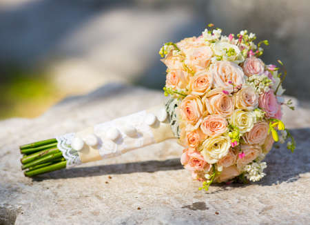 Bridal bouquet laying on the stoneの写真素材