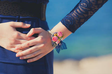 Woman hand with bracelet of rose flowersの写真素材