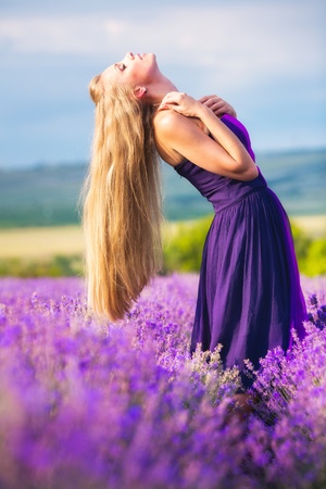 Blond girl with long hair on lavender fieldの写真素材