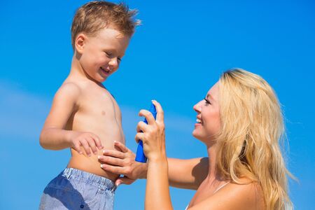 Mother with son on the beachの写真素材