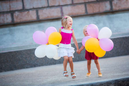 Little girls with color balloonsの写真素材