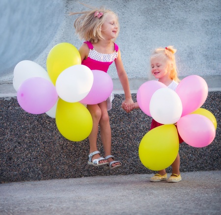 Little girls with color balloonsの写真素材