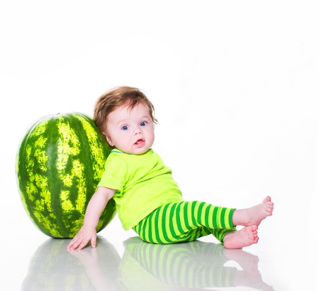 Little boy with watermelon isolated on whiteの写真素材