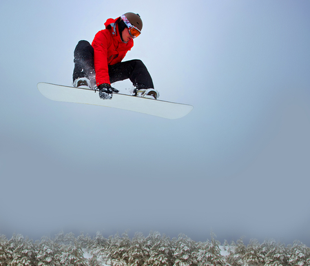 Snowboarder flying in the air の写真素材