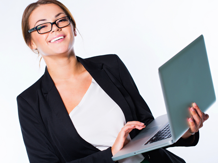 Businesswoman with laptop in hands isolated on whiteの写真素材