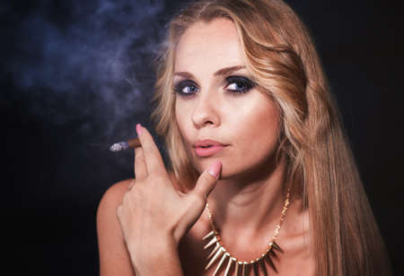 Beautiful blond woman portrait with cigar
