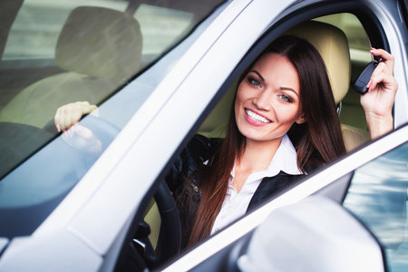 Beautiful young woman in the carの写真素材