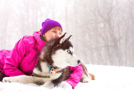 Beautiful girl with husky dogの写真素材