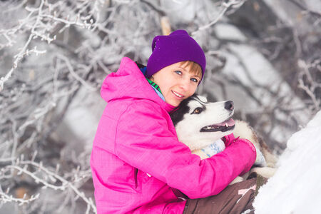 Beautiful girl with husky dogの写真素材