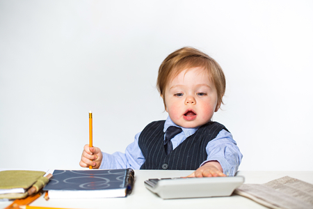 Little businessman portrait in officeの写真素材