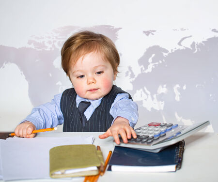 Little businessman portrait in officeの写真素材
