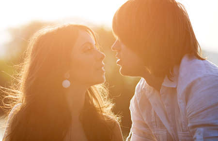 Young people kissing on sunset