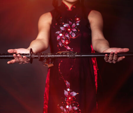 Woman with japan sword katana in handsの写真素材