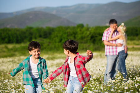 Happy family on the chamomile meadowの写真素材