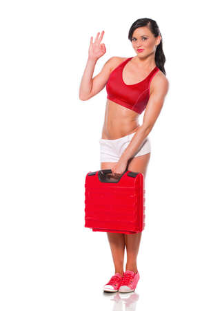 Beautiful muscular girl with case for instrumentの写真素材