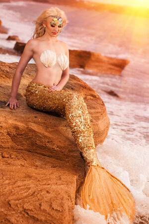 Mermaid sitting on the seashoreの写真素材