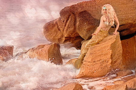 Mermaid sitting on the seashoreの写真素材