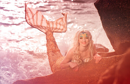 Mermaid sitting on the seashoreの写真素材
