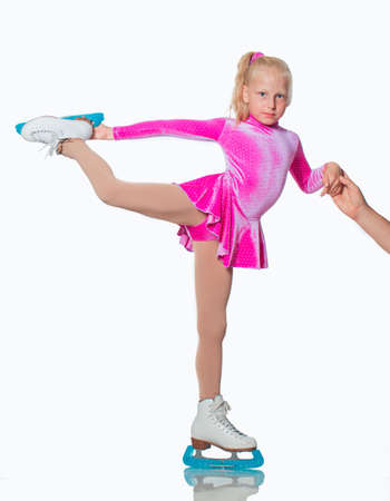 Little beautiful girl portrait in skates on the iceの写真素材
