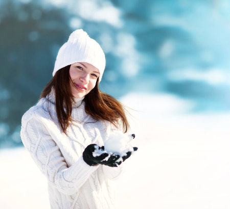 Girl playing with snow in parkの写真素材