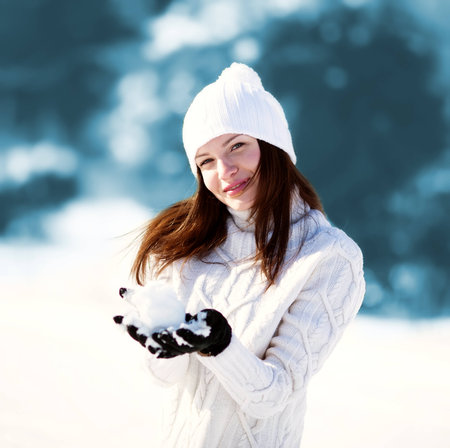 Girl playing with snow in parkの写真素材