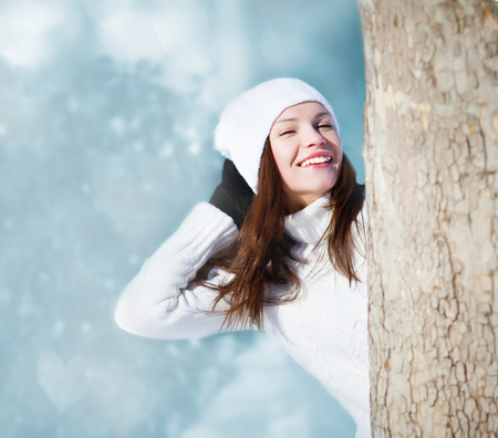 Girl playing with snow in parkの写真素材