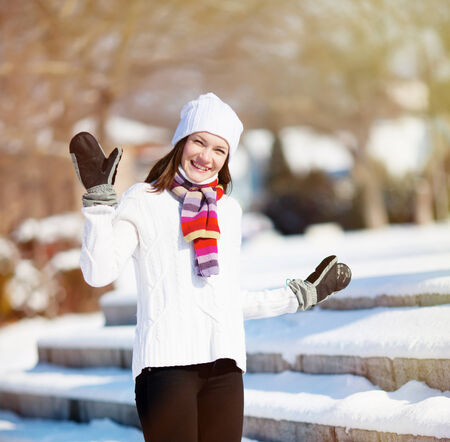 Girl playing with snow in parkの写真素材