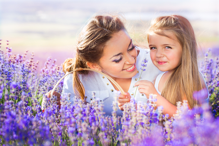 Mother with daughter on the lavender fieldの写真素材