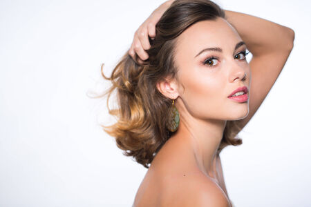 Beautiful face of young adult woman with clean fresh skin - isolated on whiteの写真素材