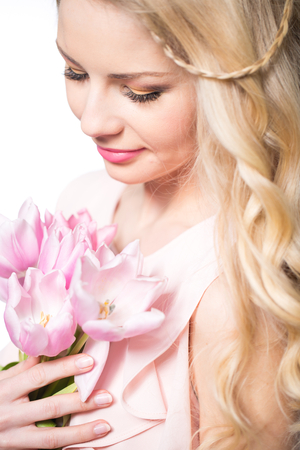 Young beautiful woman portrait with bouquet of tulip flowersの写真素材