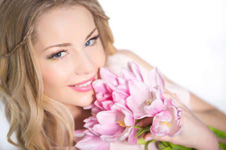 Young beautiful woman portrait with bouquet of tulip flowersの写真素材