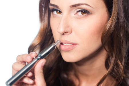 Young woman portrait with e-cigaretteの写真素材