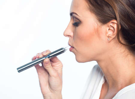 Young woman portrait with e-cigaretteの写真素材