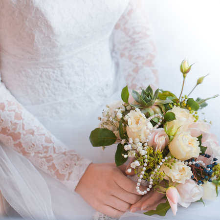 Bride holding bouquet of rose flowers in handsの写真素材