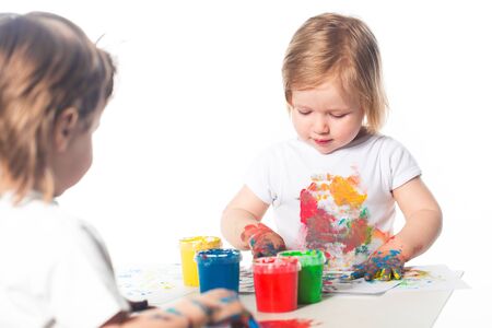 Children playing with finger paintsの写真素材
