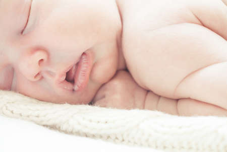 Infant boy sleeping in bedの写真素材
