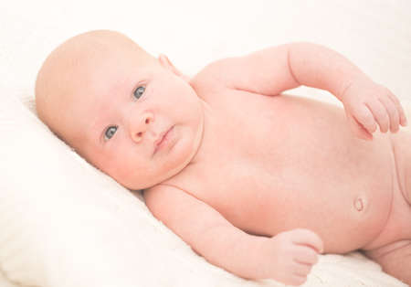 Infant boy laying on the bedの写真素材
