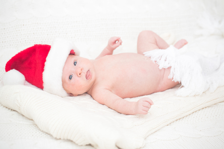 Infant boy laying on the bedの写真素材