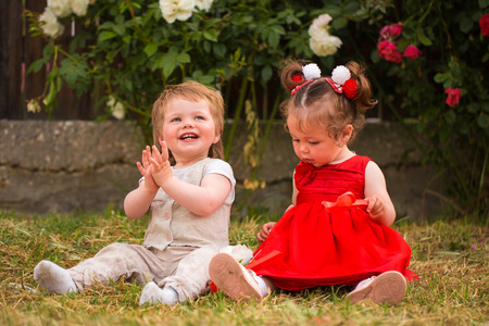 Little boy and girl playing in the gardenの写真素材