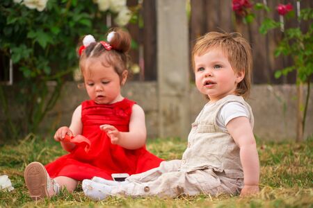 Little boy and girl playing in the gardenの写真素材