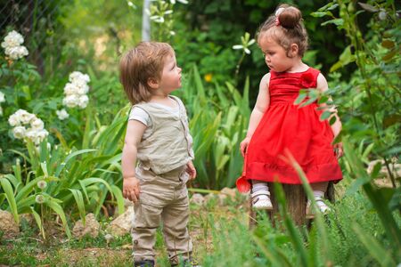 Little boy and girl playing in the gardenの写真素材